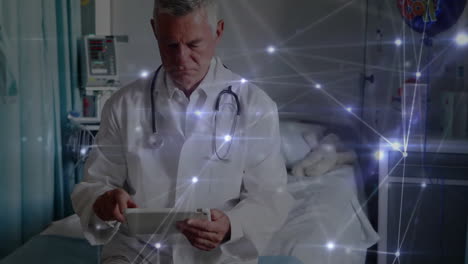 Animation-of-network-of-connections-over-caucasian-male-doctor-using-tablet
