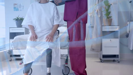 Animation-of-dna-over-diverse-male-doctor-and-senior-female-patient-with-prosthetic-leg-talking
