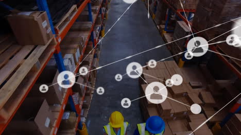 Animation-of-network-of-people-icons-over-diverse-workers-moving-boxes-at-warehouse