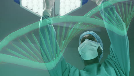 Animation-of-dna-strand-rotating-over-african-american-female-surgeon-working-in-theatre
