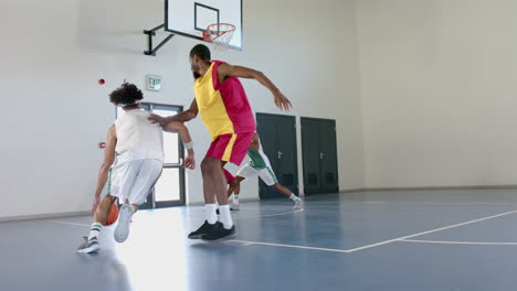 Young-African-American-men-play-basketball-indoors,-with-copy-space