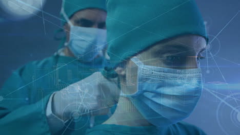 Animation-of-network-and-city-plan-over-caucasian-male-and-female-surgeons-putting-on-face-mask