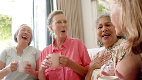 Senior-diverse-group-of-women-share-a-joyful-moment-over-coffee