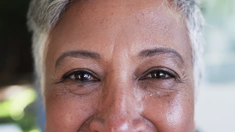 Close-up-of-a-biracial-woman's-face,-highlighting-her-eyes-and-smile-lines