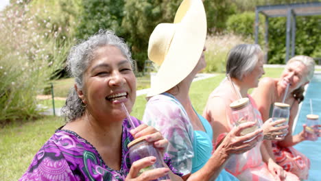 Senior-biracial-woman-enjoys-a-sunny-outdoor-gathering