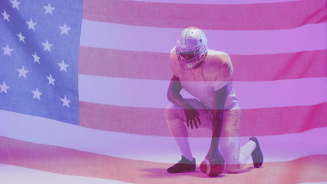 Animation-of-african-american-american-football-player-kneeling-with-ball-and-flag-of-usa