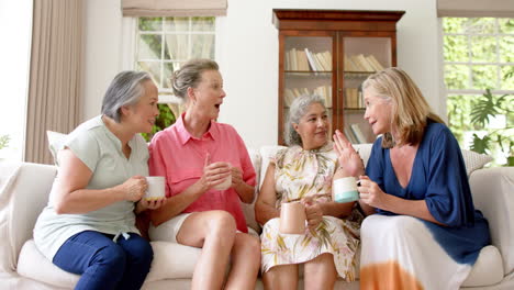 Senior-Asian-woman-and-two-senior-Caucasian-women-enjoy-a-conversation-at-home