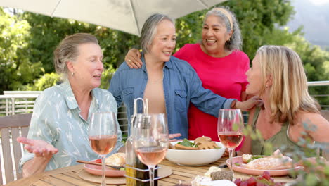 Senior-diverse-group-of-women-sharing-a-laugh-at-an-outdoor-gathering