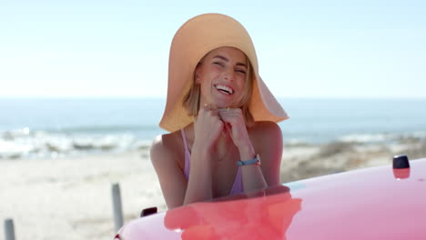 A-young-Caucasian-woman-enjoys-the-beachside-on-a-road-trip