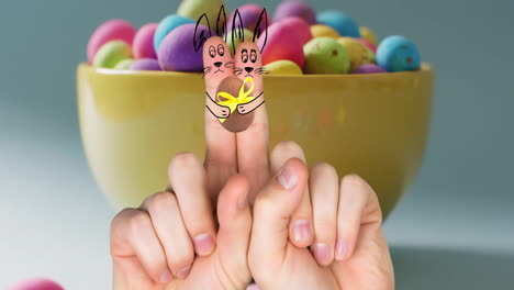 Animation-of-fingers-with-easter-bunnies-and-easter-egg-over-bowl-of-easter-eggs-on-blue-background