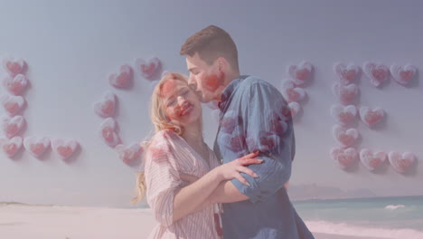 Animation-of-love-text-formed-with-hearts-over-happy-caucasian-couple-on-beach-by-sea