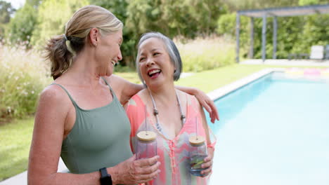 Senior-Caucasian-friends-enjoy-a-hearty-laugh-outdoors-by-the-pool