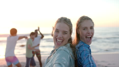 Two-young-Caucasian-women-enjoy-a-beach-outing-at-a-party,-with-copy-space