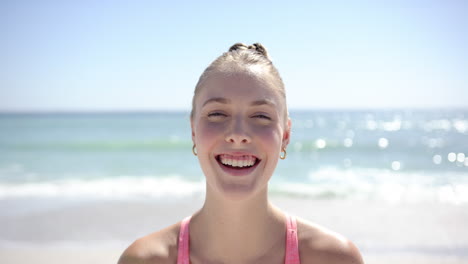 Young-Caucasian-woman-smiles-brightly-on-a-sunny-beach
