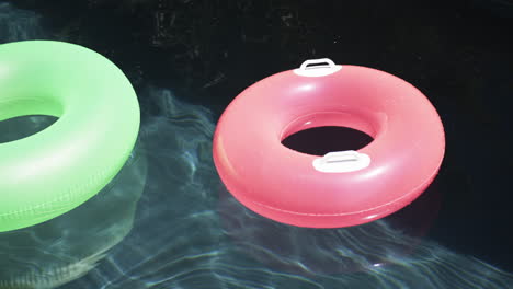 Two-colorful-swim-rings-float-on-the-water's-surface