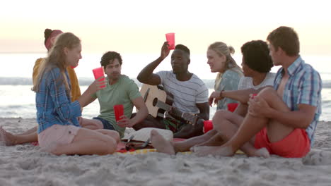 Diverse-group-of-friends-enjoy-a-beach-gathering-at-a-party