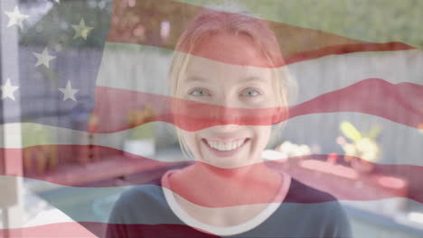 Animation-of-smiling-caucasian-woman-over-flag-of-usa