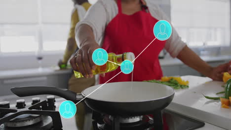 Animation-of-network-of-connections-with-icons-over-senior-african-american-couple-cooking