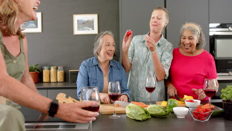 Senior-diverse-group-of-women-enjoy-a-meal-together-at-home