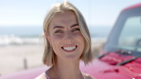 Young-Caucasian-woman-smiles-brightly-outdoors-on-a-road-trip