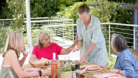 Senior-diverse-group-of-women-enjoy-a-meal-outdoors