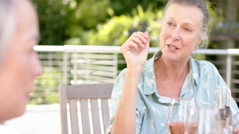 Senior-Caucasian-woman-enjoys-a-conversation-outdoors