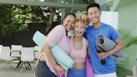 Diverse-friends-smile-after-a-yoga-session-at-home