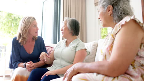 Senior-diverse-group-of-women-share-a-conversation-at-home