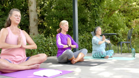 Senior-diverse-group-of-women-practicing-yoga-outdoors