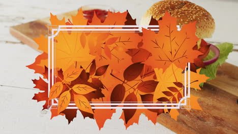 Animation-of-frame-with-fall-leaves-over-hamburger