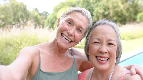 Senior-diverse-friends-smile-for-a-selfie-outdoors