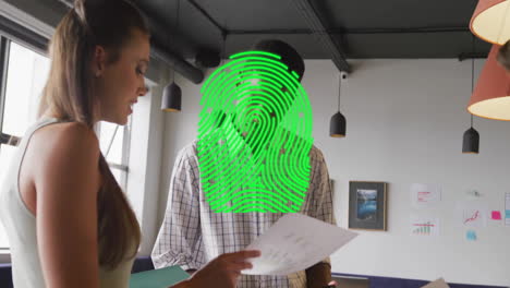 Animation-of-fingerprint-over-diverse-colleagues-working-in-creative-office