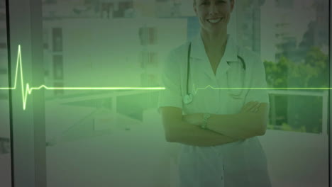Animation-of-green-heartbeat-monitor-over-smiling-caucasian-female-doctor-at-hospital