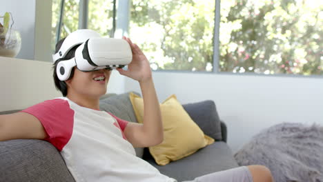Teenage-Asian-boy-enjoys-a-virtual-reality-headset-at-home
