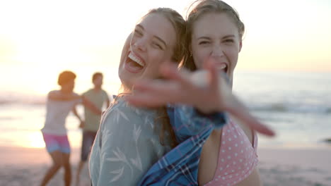Two-young-Caucasian-women-enjoy-a-playful-moment-on-the-beach-at-a-party