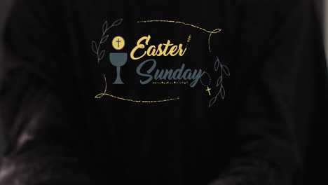 Animation-of-eastersunday-text-with-biracial-woman's-hands-on-black-background