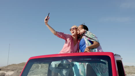 Diverse-couple-takes-a-selfie-on-road-trip-with-copy-space-on-road-trip,-slow-motion