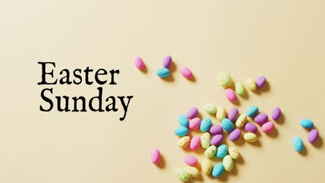 Animation-of-eastersunday-text-over-colourful-easter-eggs-on-yellow-background