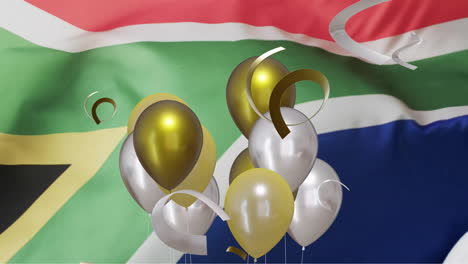 Animation-of-confetti-and-balloons-over-white-rugby-ball-and-flag-of-south-africa