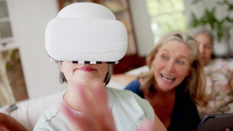 Caucasian-and-senior-biracial-women-explore-virtual-reality-at-home