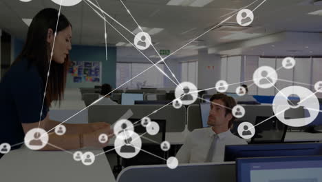 Animation-of-network-of-connections-with-people-icons-over-diverse-business-people-in-office