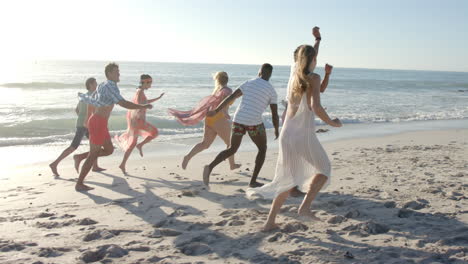 Diverse-friends-enjoy-a-lively-run-on-the-beach