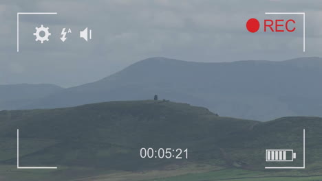 Animation-of-digital-video-camera-interface-over-rural-landscape-background