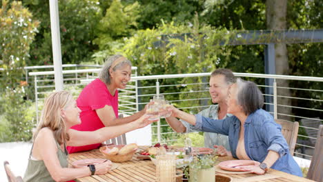 Senior-diverse-group-of-women-enjoying-a-meal-outdoors