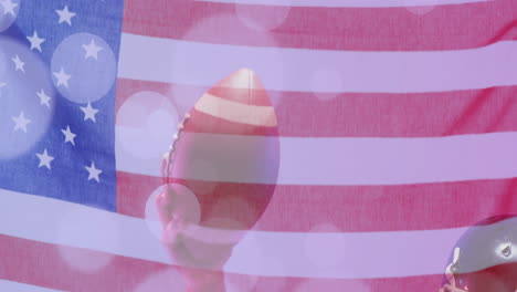 Animation-of-caucasian-american-football-player-holding-ball-and-flag-of-usa