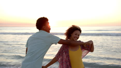 Biracial-couple-enjoys-a-serene-beach-sunset-with-copy-space,-their-faces-close-together
