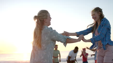 Caucasian-couple-enjoys-a-sunset-beach-dance-at-a-party,-with-copy-space