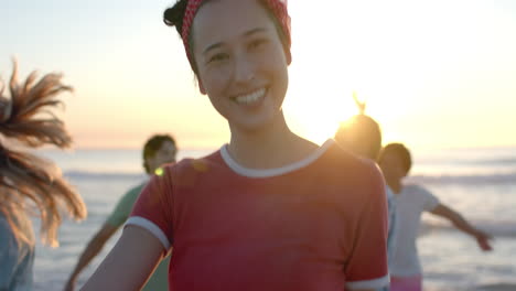 Young-Caucasian-woman-smiles-at-the-beach-during-sunset-at-a-party