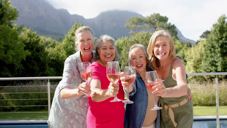 Diverse-group-of-women-toast-outdoors