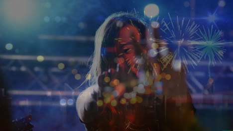 Animation-of-light-spots-and-fireworks-over-caucasian-woman-singing